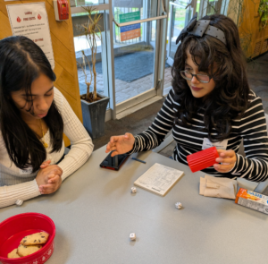 Two students playing Yahtzee.
